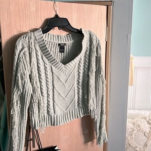 light green sweater with fringe